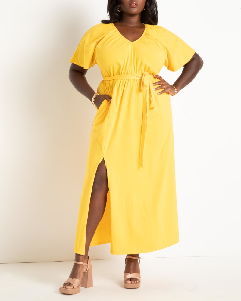 Front of a model wearing a size 16 Knit Maxi Dress With Slit in Lemon Chrome by ELOQUII. | dia_product_style_image_id:292912
